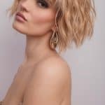 Blonde wavy wig styled on a model with makeup and earrings.